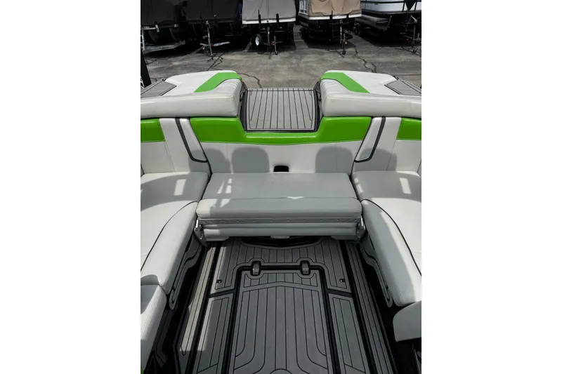 Slide: The Image of 2014 Nautique Super Air Nautique G21 interior with green and gray seating. - 16