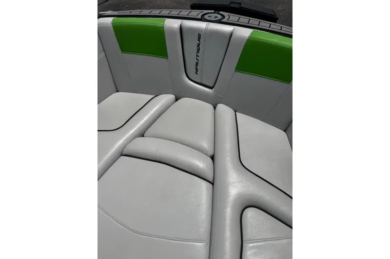 Slide: The Image of 2014 Nautique Super Air Nautique G21 boat interior with gray and green upholstery. - 24