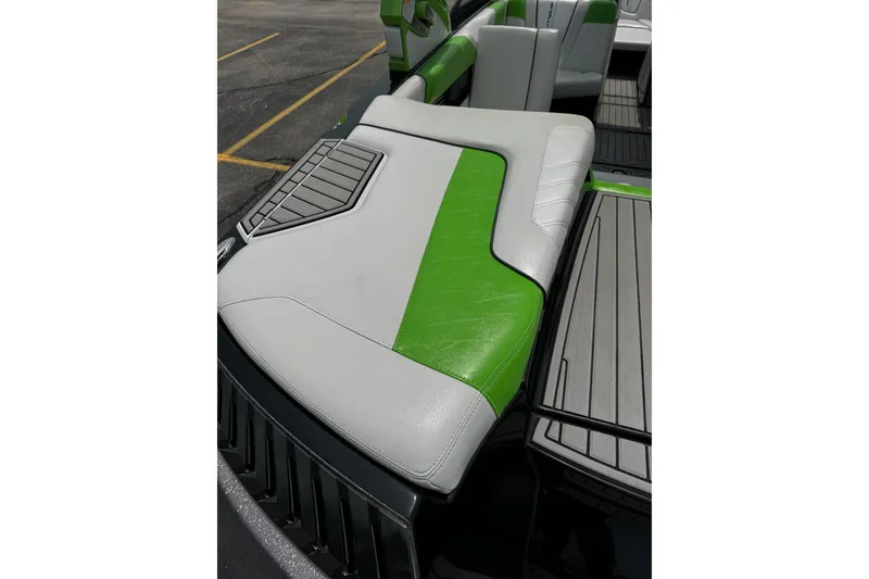 Slide: The Image of 2014 Nautique Super Air Nautique G21 boat interior with green and gray seating. - 10