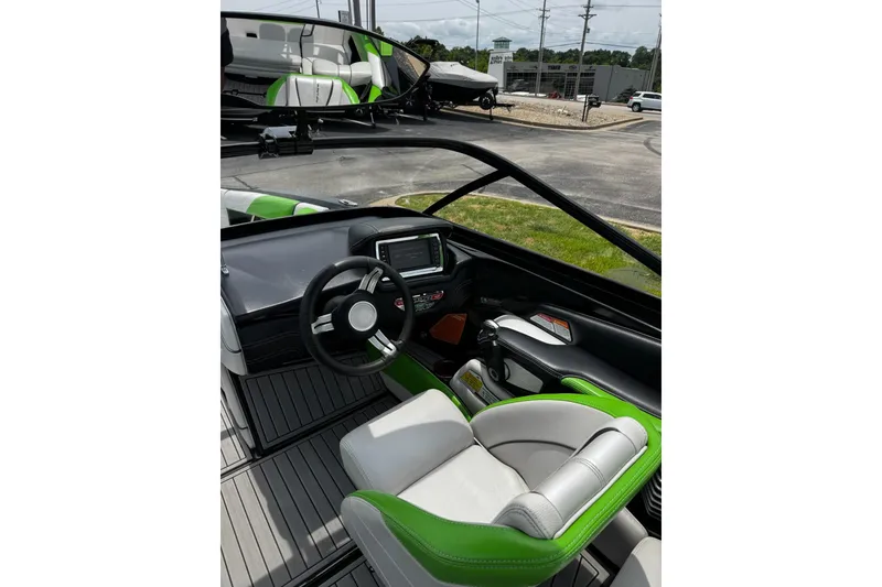 Slide: The Image of Interior of 2014 Nautique Super Air Nautique G21 boat with green and white seating. - 14