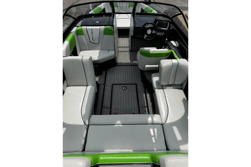 Slide: The Image of 2014 Nautique Super Air Nautique G21 interior with gray and green seating, sleek design. - 12