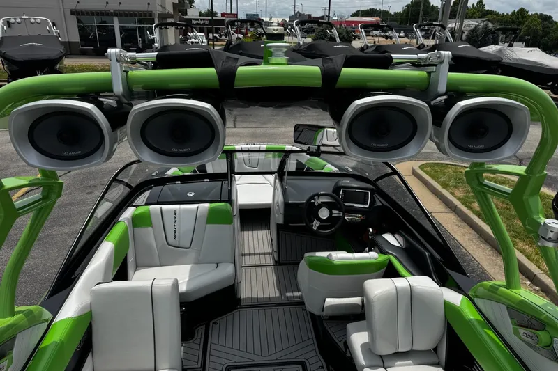 Slide: The Image of 2014 Nautique Super Air Nautique G21 interior with green accents and premium audio system. - 13