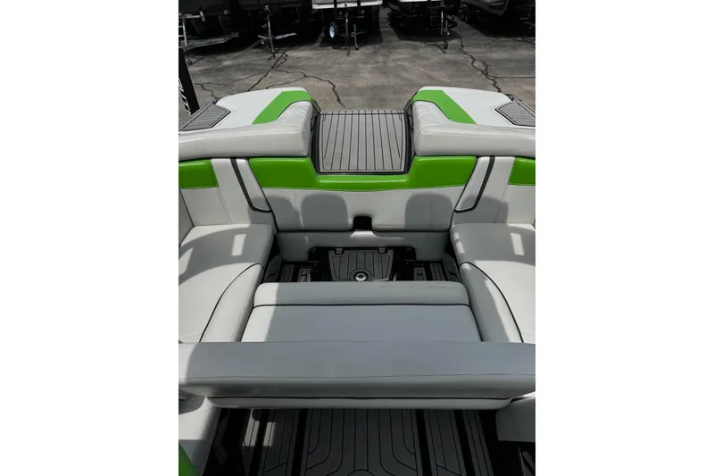 Slide: The Image of 2014 Nautique Super Air Nautique G21 interior with green and gray seating. - 17