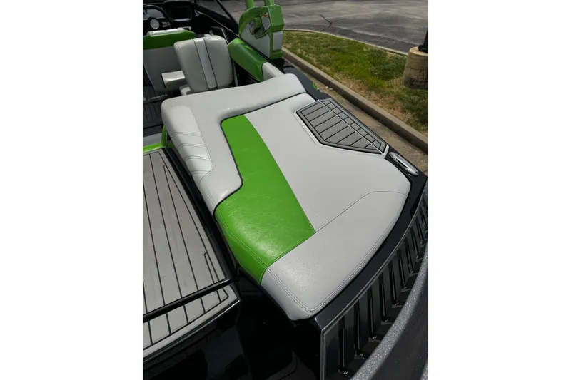 Slide: The Image of 2014 Nautique Super Air Nautique G21 boat interior with green and gray seating. - 11