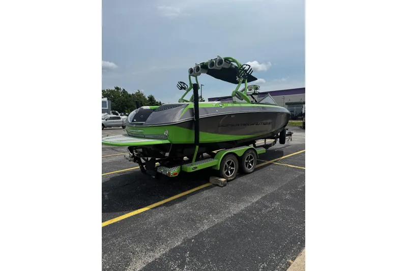 Slide: The Image of 2014 Nautique Super Air Nautique G21 boat on trailer, vibrant green and gray design. - 27