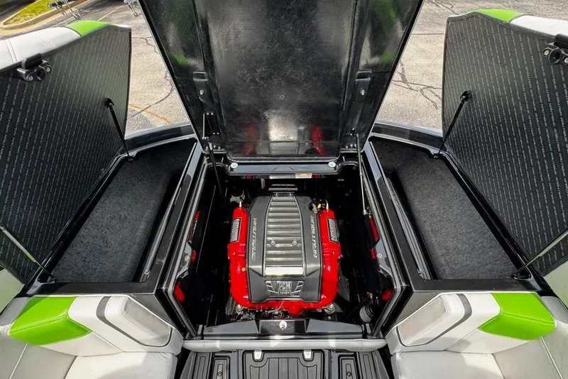 Slide: The Image of 2014 Nautique Super Air Nautique G21 engine compartment with open hatches, showcasing powerful engine. - 18