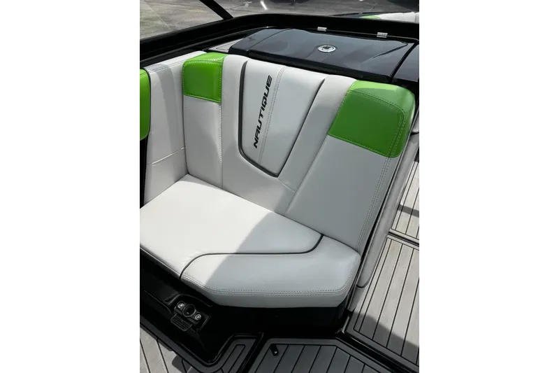 Slide: The Image of 2014 Nautique Super Air Nautique G21 boat seat with green and white upholstery. - 15