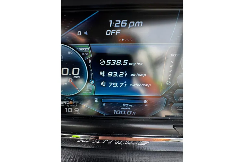 Slide: The Image of Dashboard display of a 2014 Nautique Super Air Nautique G21 boat showing engine hours and temperatures. - 22