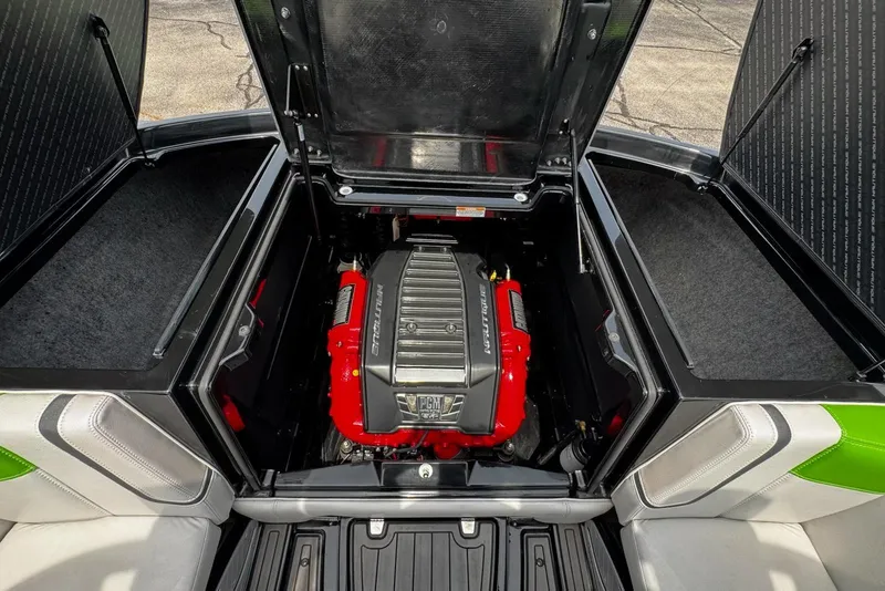 Slide: The Image of 2014 Nautique Super Air Nautique G21 engine compartment with red engine cover. - 19