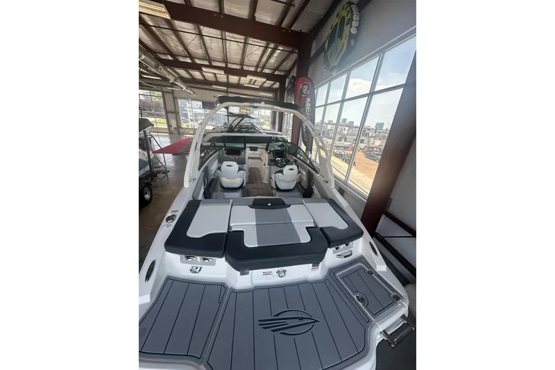Slide: The Image of 2026 Chaparral 21 SSi boat interior with sleek seating and modern design in showroom. - 3