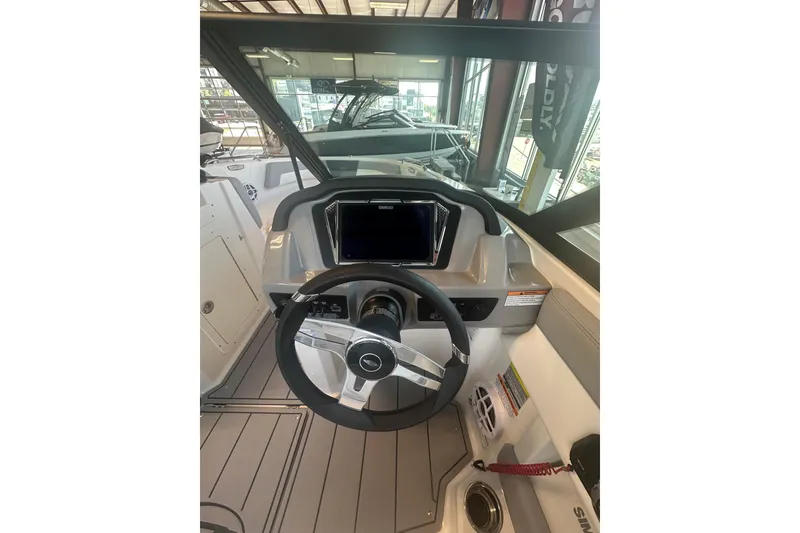 Slide: The Image of 2026 Chaparral 21 SSi boat dashboard with steering wheel and navigation display. - 5