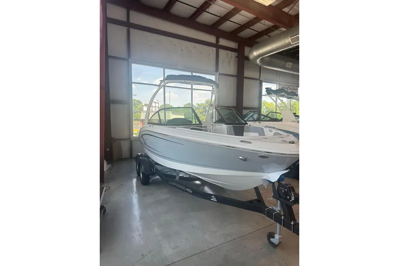 Slide: The Image of 2026 Chaparral 21 SSi boat in showroom, featuring sleek design and modern features. - 6