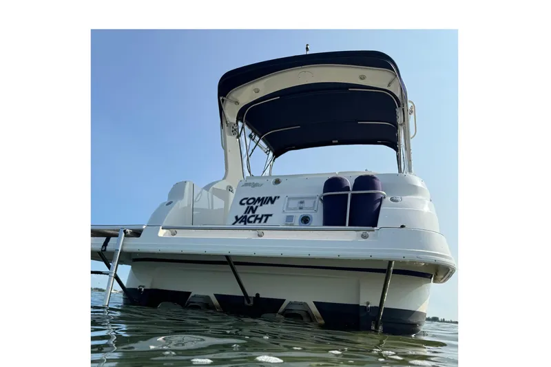 Slide: The Image of 2004 Cruisers Yachts 280 CXi Express on water, rear view with canopy. - 2