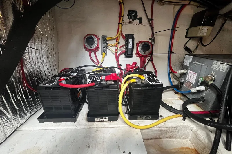 Slide: The Image of Battery compartment of 2004 Cruisers Yachts 280 CXi Express with wiring and connections. - 19