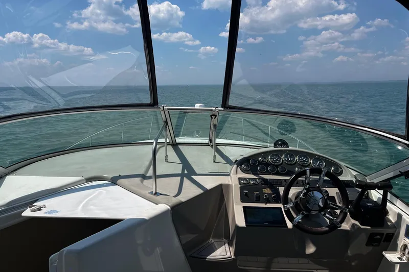 Slide: The Image of 2004 Cruisers Yachts 280 CXi Express helm with ocean view under a clear sky. - 8