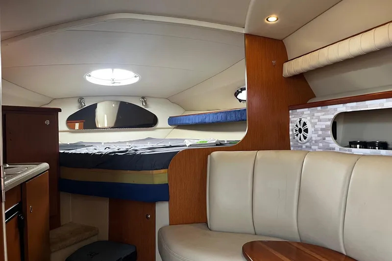 Slide: The Image of Interior of 2004 Cruisers Yachts 280 CXi Express, featuring cozy seating and modern amenities. - 20