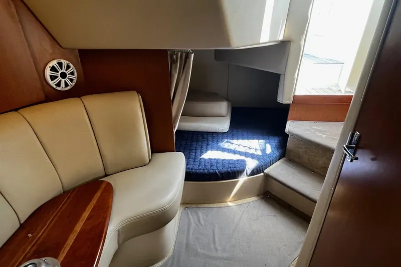 Slide: The Image of Interior of 2004 Cruisers Yachts 280 CXi Express, featuring seating and cabin area. - 22