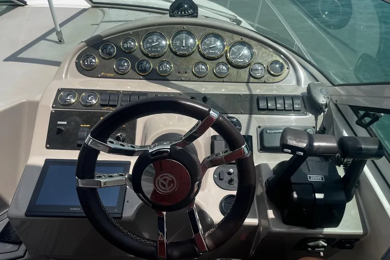Slide: The Image of Dashboard of a 2004 Cruisers Yachts 280 CXi Express with steering wheel and control panel. - 9