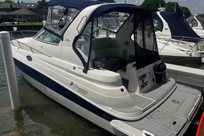 Slide: The Image of 2004 Cruisers Yachts 280 CXi Express docked, featuring sleek design and spacious cockpit. - 5