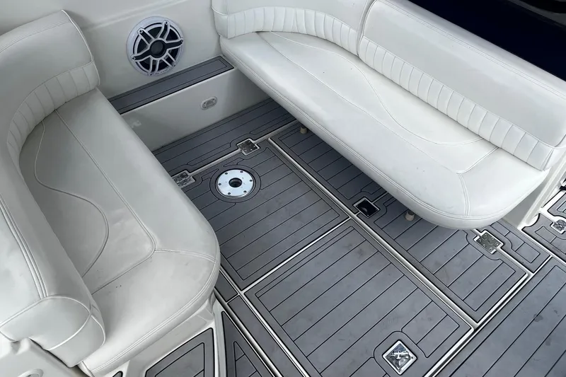 Slide: The Image of 2004 Cruisers Yachts 280 CXi Express interior with white seating and gray flooring. - 12