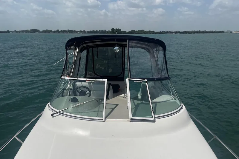 Slide: The Image of 2004 Cruisers Yachts 280 CXi Express on calm water, featuring a sleek design. - 14