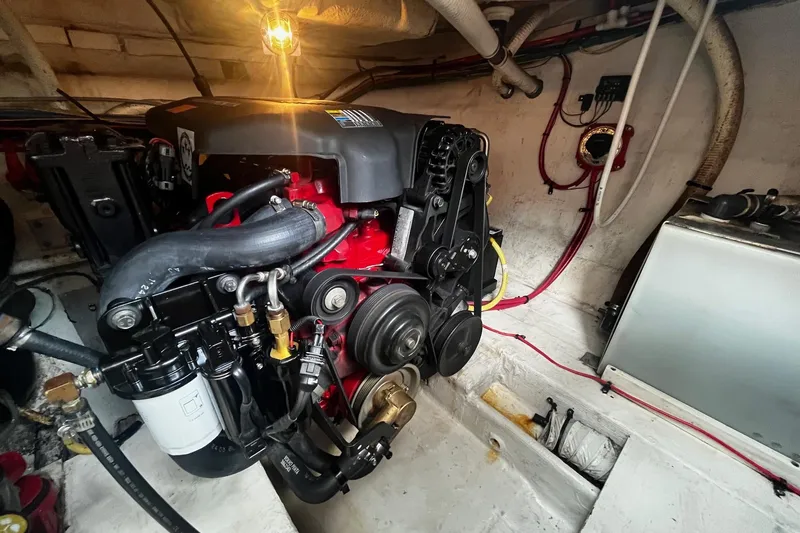 Slide: The Image of Engine room of 2004 Cruisers Yachts 280 CXi Express, showcasing detailed mechanical components. - 16