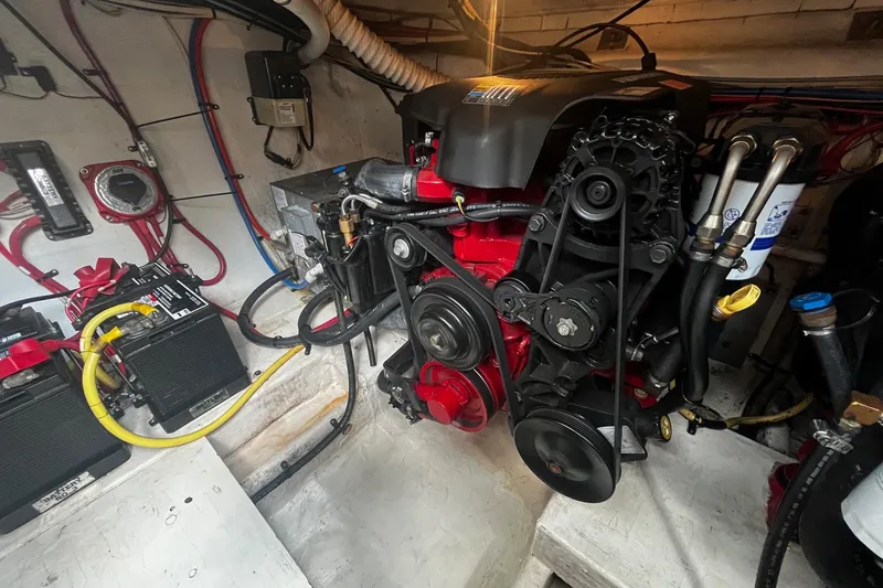 Slide: The Image of Engine compartment of a 2004 Cruisers Yachts 280 CXi Express, showcasing detailed mechanical components. - 17