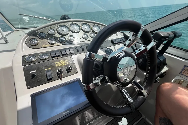 Slide: The Image of Steering wheel and dashboard of 2004 Cruisers Yachts 280 CXi Express on open water. - 7