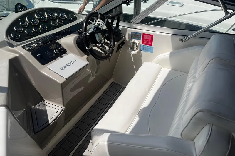 Slide: The Image of 2004 Cruisers Yachts 280 CXi Express cockpit with steering wheel and Garmin navigation system. - 6