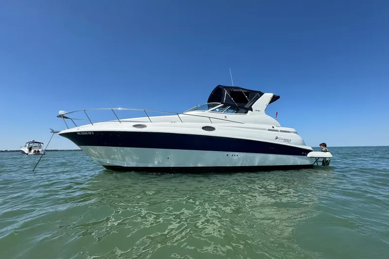 Slide: The Image of 2004 Cruisers Yachts 280 CXi Express on calm water under clear blue sky. - 1