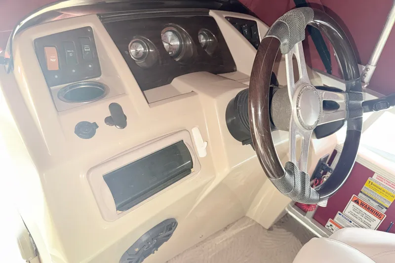 Slide: The Image of 2012 Bennington 20SLM boat dashboard with steering wheel and control panel. - 11