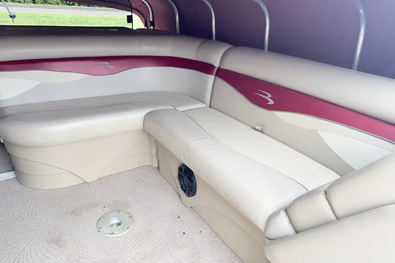 Slide: The Image of Interior seating of a 2012 Bennington 20SLM pontoon boat with beige and red upholstery. - 8