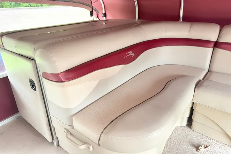 Slide: The Image of 2012 Bennington 20SLM boat interior with beige and red seating. - 7