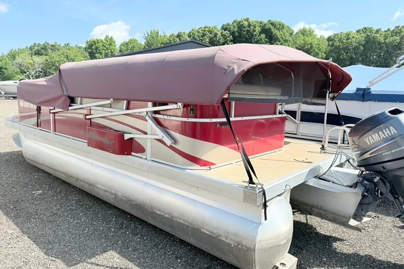 Slide: The Image of 2012 Bennington 20SLM pontoon boat with maroon canopy and Yamaha outboard motor. - 3