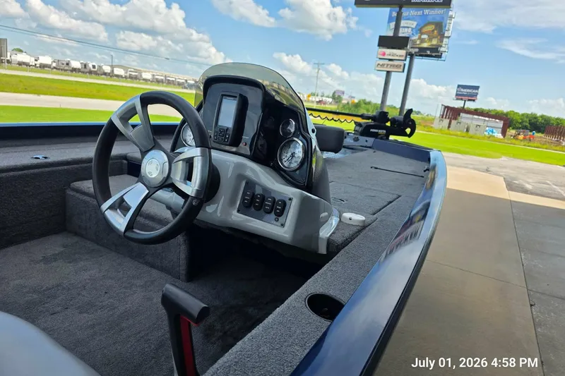 Slide: The Image of 2017 G3 Sportsman 18 boat dashboard with steering wheel and controls, outdoors. - 7