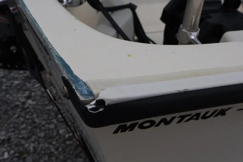 Slide: The Image of 1991 Boston Whaler 170 Montauk boat with visible hull damage. - 34