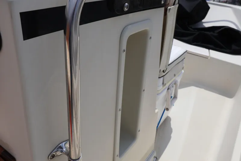 Slide: The Image of 1991 Boston Whaler 170 Montauk interior detail with chrome railing and seating. - 15