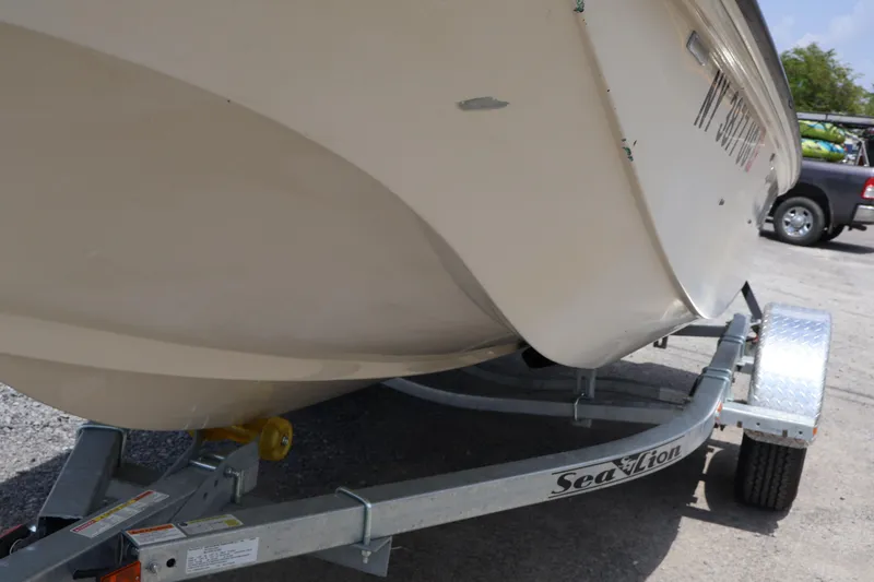 Slide: The Image of 1991 Boston Whaler 170 Montauk boat on Sea Lion trailer, parked outdoors. - 2