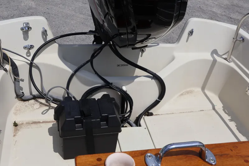 Slide: The Image of 1991 Boston Whaler 170 Montauk boat interior with motor and battery compartment. - 26