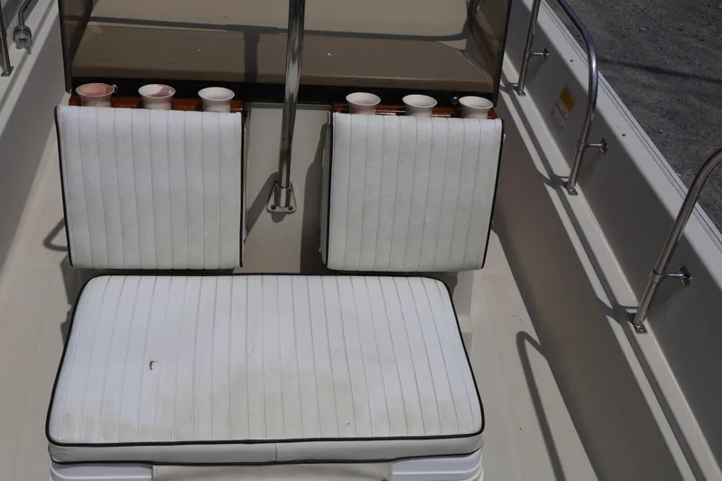 Slide: The Image of Interior seating of a 1991 Boston Whaler 170 Montauk boat with white cushions. - 21