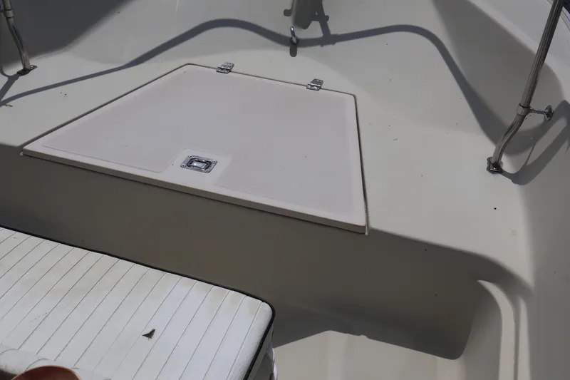 Slide: The Image of 1991 Boston Whaler 170 Montauk boat interior with storage compartment and seating. - 17