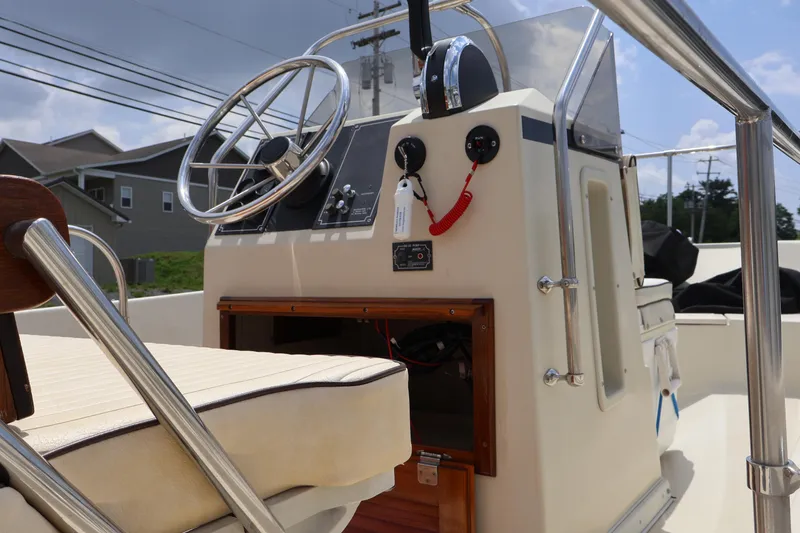 Slide: The Image of 1991 Boston Whaler 170 Montauk boat console with steering wheel and controls. - 11
