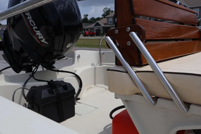 Slide: The Image of 1991 Boston Whaler 170 Montauk boat interior with Mercury engine and wooden seating. - 9