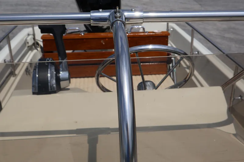 Slide: The Image of 1991 Boston Whaler 170 Montauk boat interior with steering wheel and controls. - 24