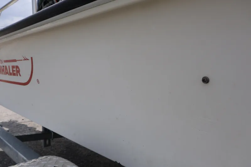 Slide: The Image of 1991 Boston Whaler 170 Montauk boat side view with logo visible. - 6