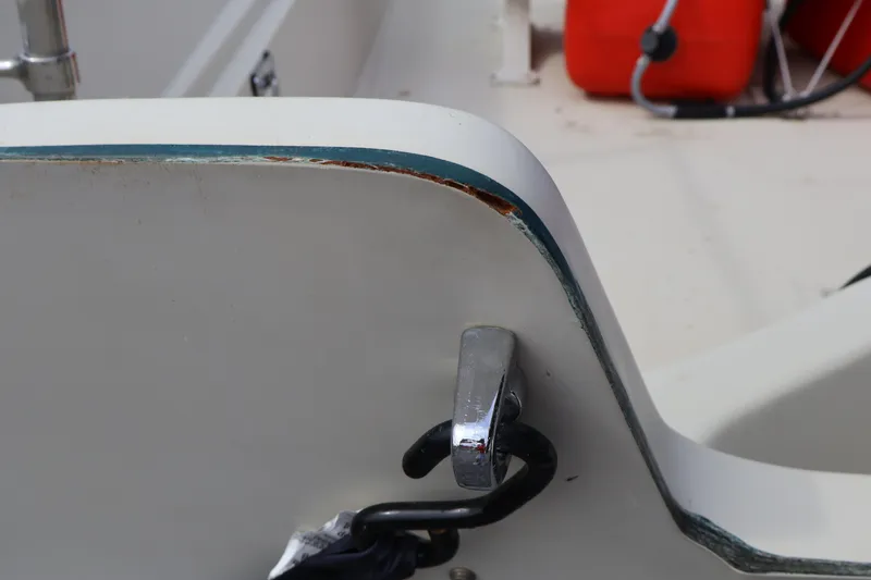 Slide: The Image of Close-up of a 1991 Boston Whaler 170 Montauk boat's edge with visible wear. - 33