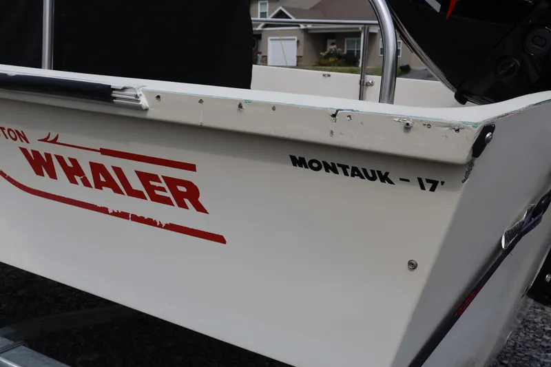 Slide: The Image of 1991 Boston Whaler 170 Montauk boat, close-up of side branding and model name. - 30