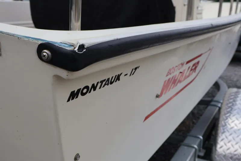 Slide: The Image of 1991 Boston Whaler 170 Montauk boat side view with logo and model name. - 38