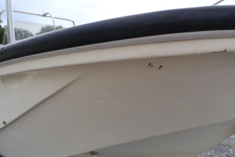 Slide: The Image of Close-up of 1991 Boston Whaler 170 Montauk boat hull with visible wear. - 36