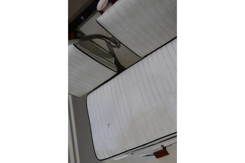 Slide: The Image of White cushioned seats on a 1991 Boston Whaler 170 Montauk boat. - 22